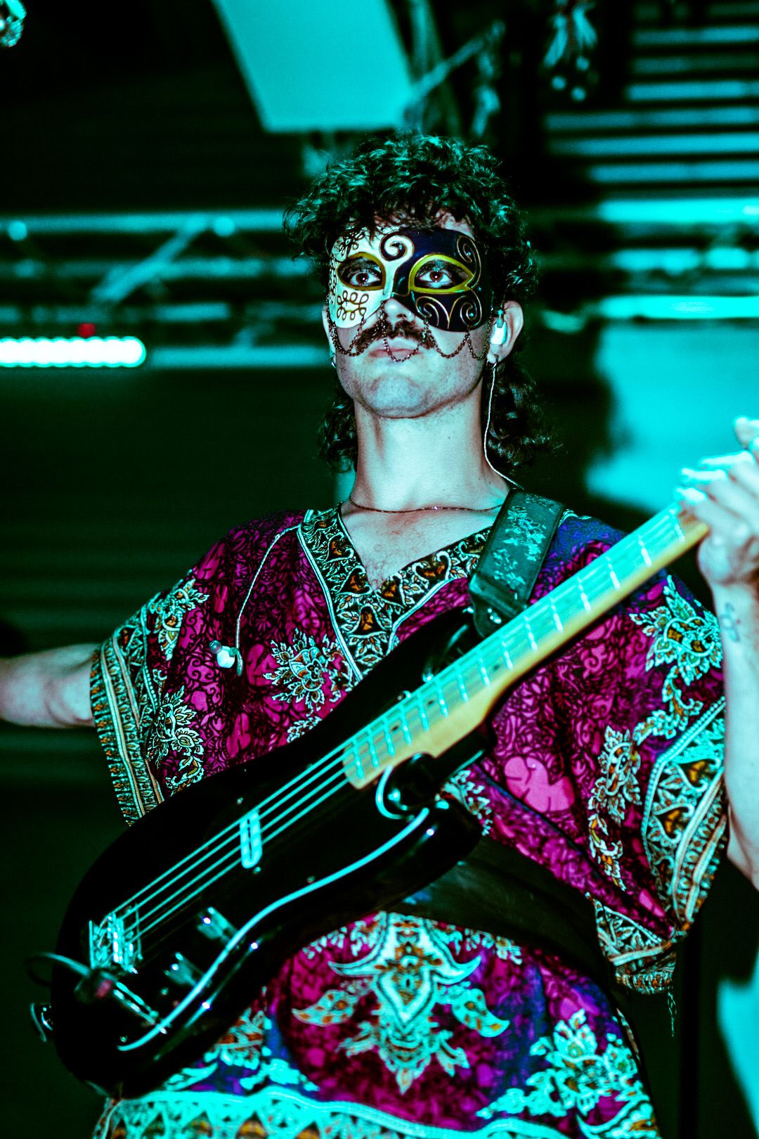Bassist with mask and tunic