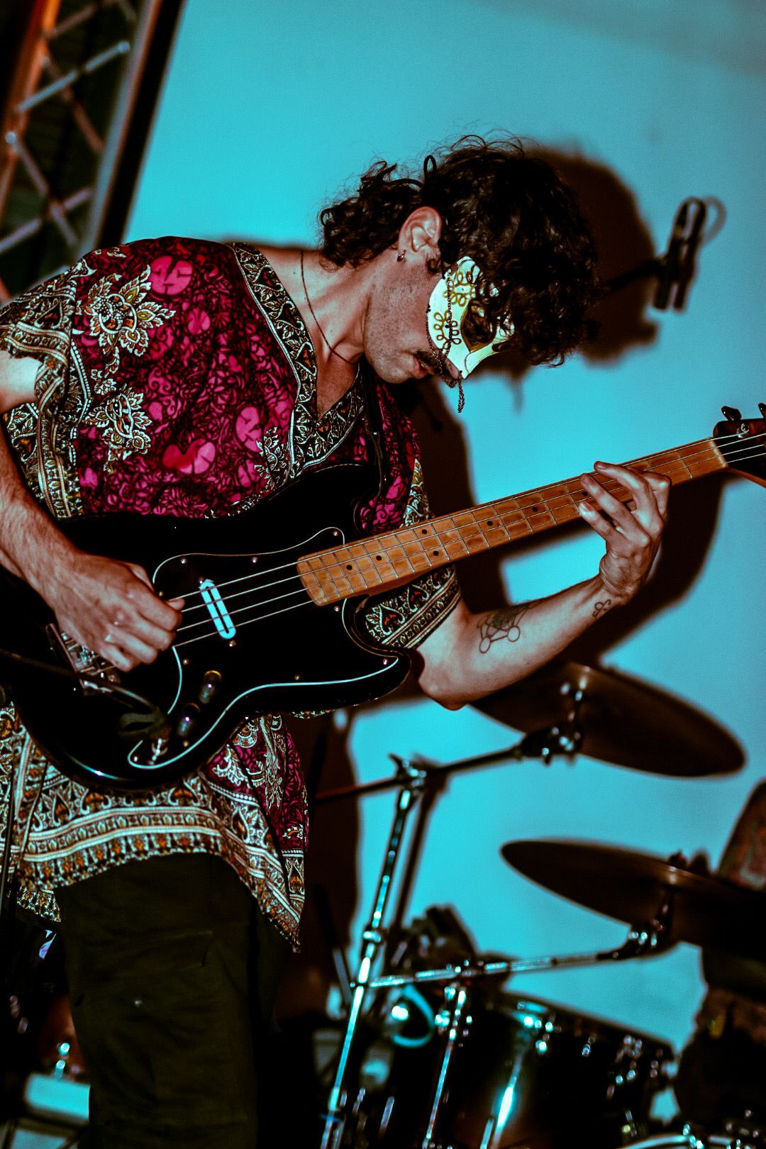 Bassist with white mask playing