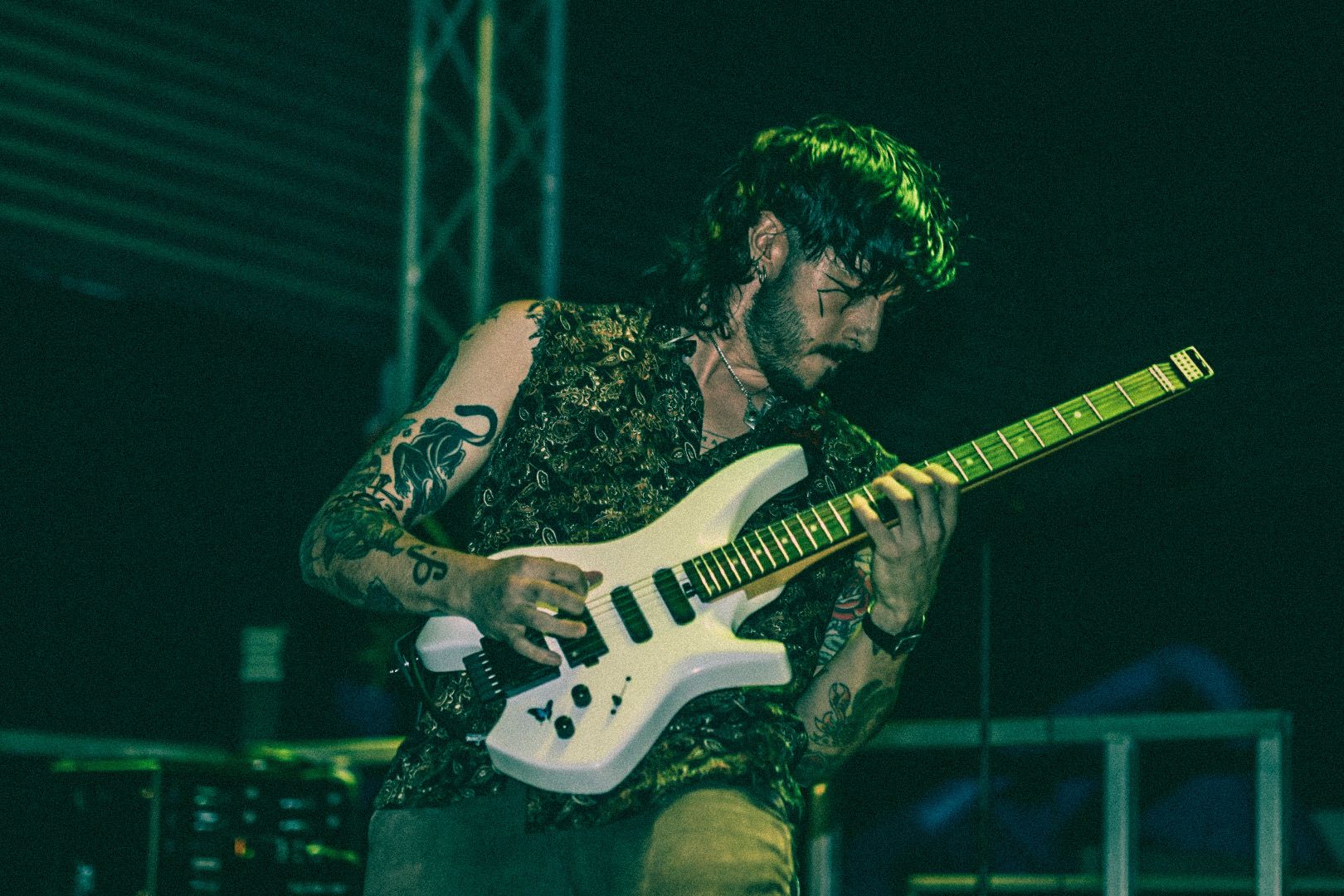 Guitarist under green lights